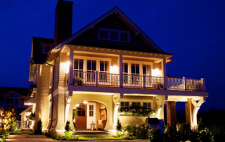 A large house with lights on the front of it.
