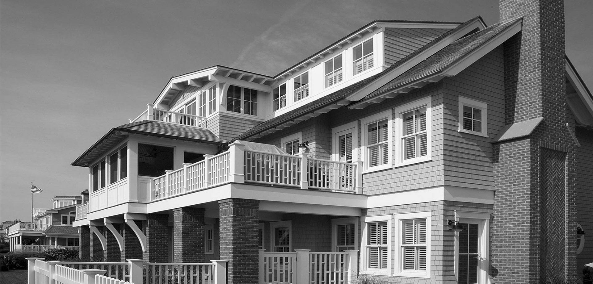 A black and white photo of a building with balconies.