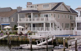 A house with a dock and a boat in the water.