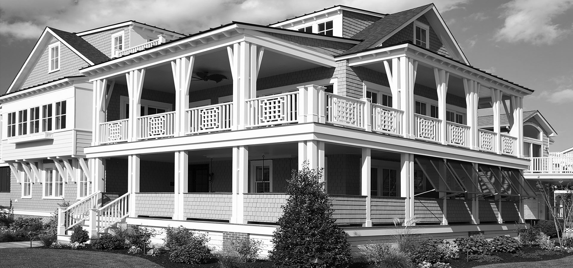 A large white house with a balcony and porch.