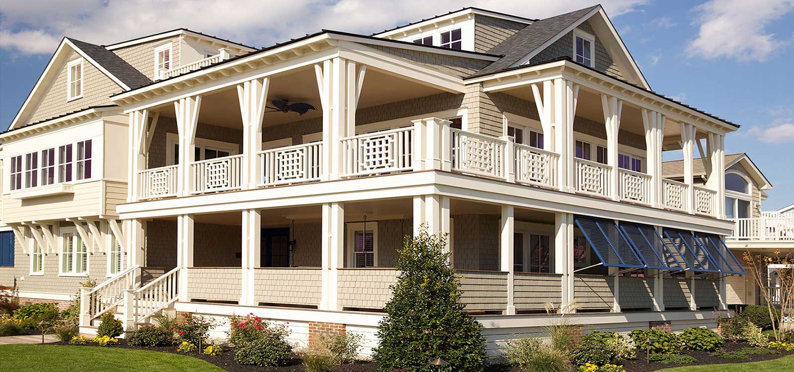 A large white house with a balcony and porch.