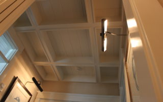 A ceiling with many wooden panels and lights