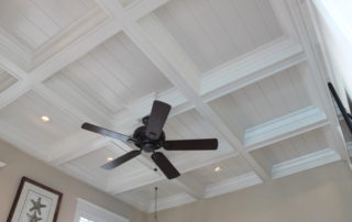 A ceiling fan in the middle of a room.