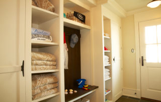 A room with shelves and drawers filled with folded towels.