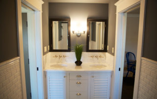 A bathroom with two sinks and mirrors in it.