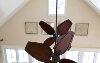 A ceiling fan in the middle of a room.