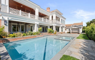 A large pool in front of a house.