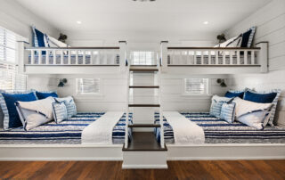 A room with two bunk beds and stairs in it