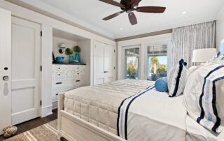 A bedroom with two beds and a ceiling fan.
