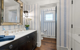A bathroom with blue and white striped walls