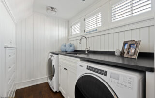 A laundry room with washer and dryer in it