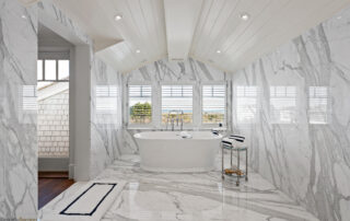 A large bathroom with marble floors and walls.