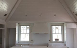 A kitchen with white walls and ceiling.