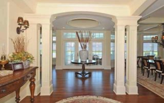 A foyer with wood floors and white walls.